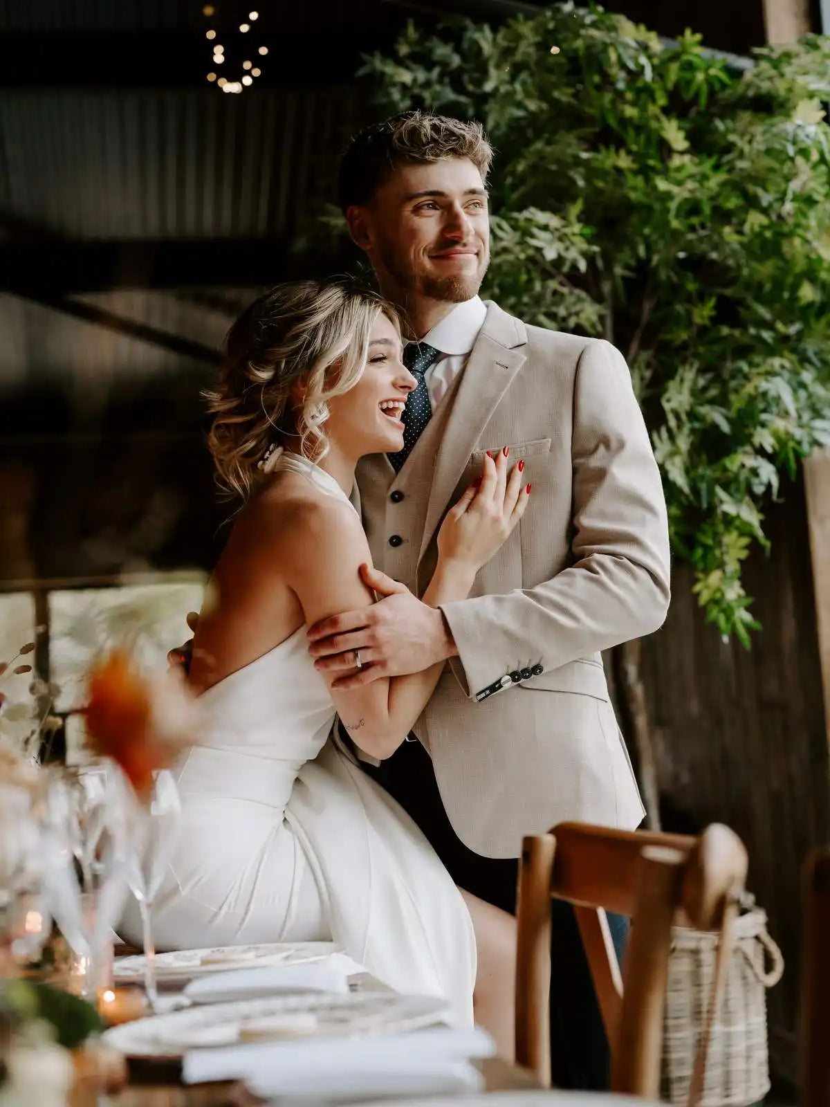 A joyful couple sharing a candid moment at their wedding reception.